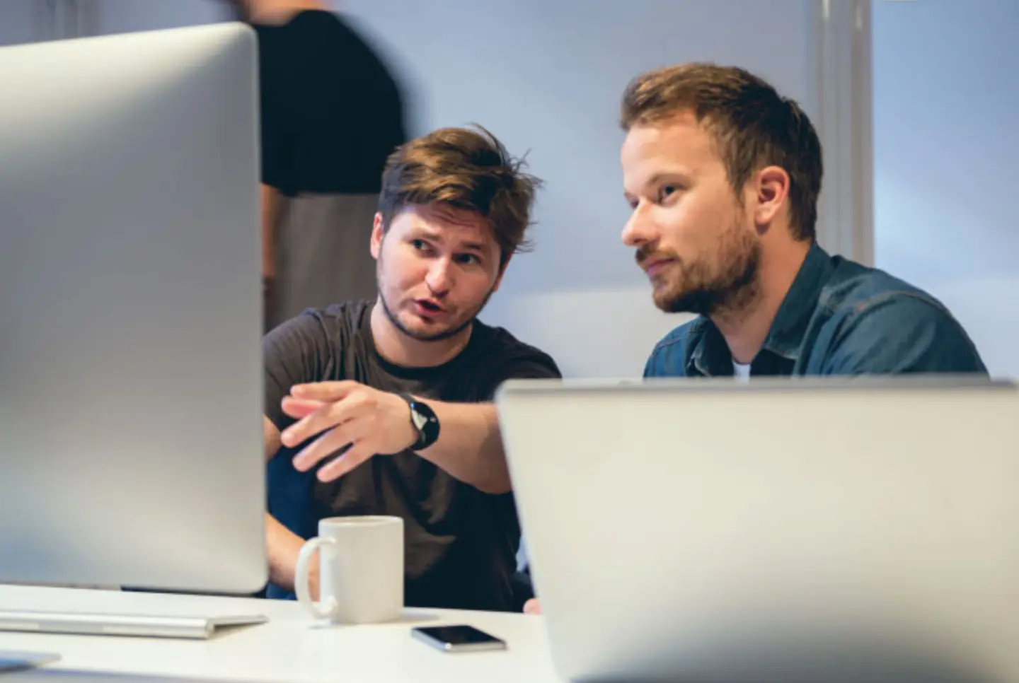 Two supply chain professionals working in a data integration project