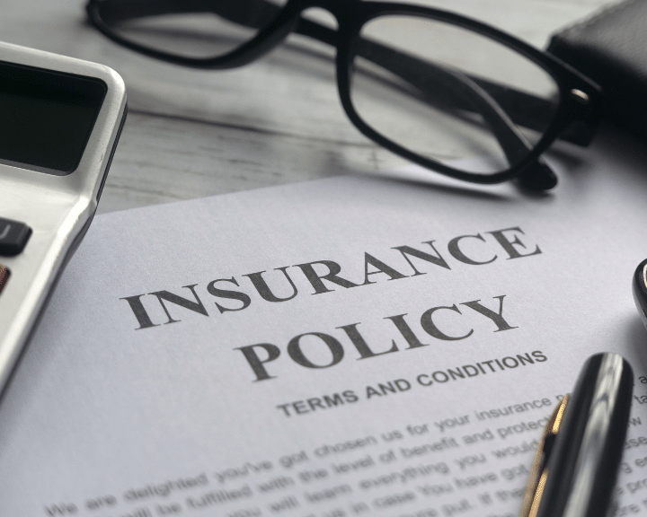 An insurance policy with glasses and calculator. Improve the efficiency of quoting and securing freight insurance with Chain.io