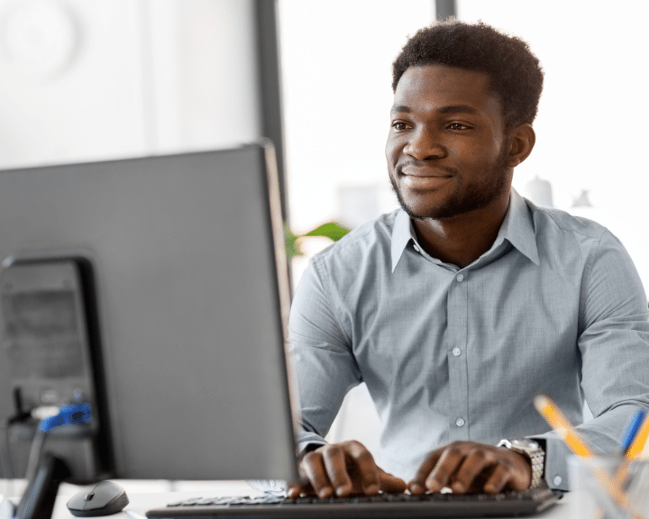 man working at computer in office to Synchronize Master Data between your core systems and key third party applications.