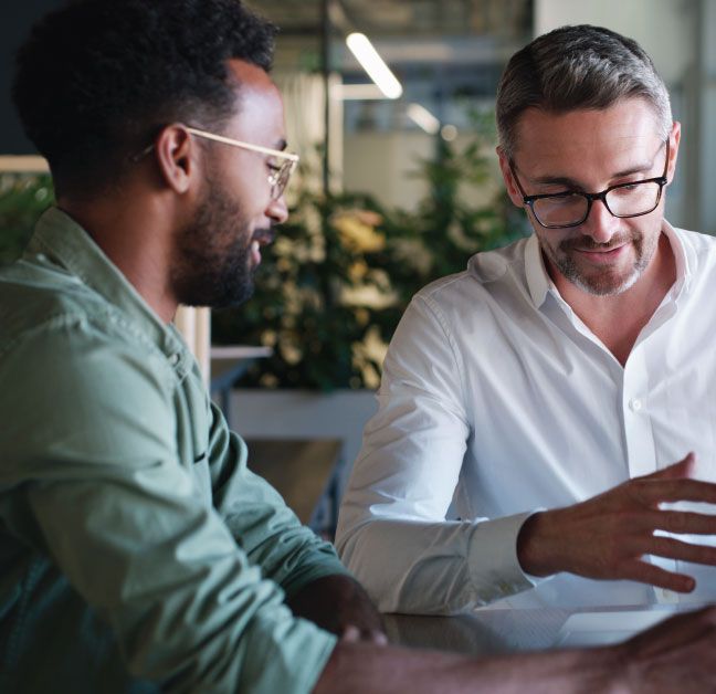 Two supply chain workers having a conversation about software.