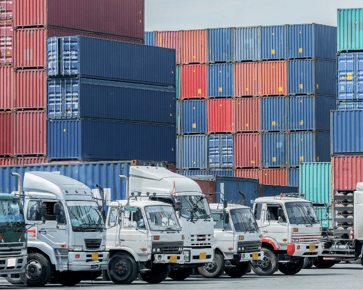 trucks await loading while supply chain executives Send and receive bookings, ISF details, attachments, and invoices from shipper customers.