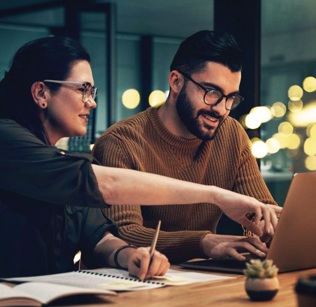 Man and woman working on laptop. 