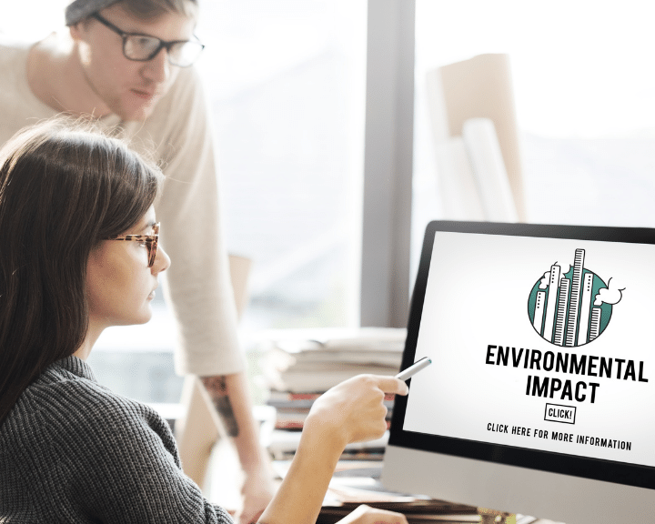Woman and man looking at a supply chain environmental impact report on a computer screen. Chain.io can help provide your customers with equivalent impact reporting from within your TMS.