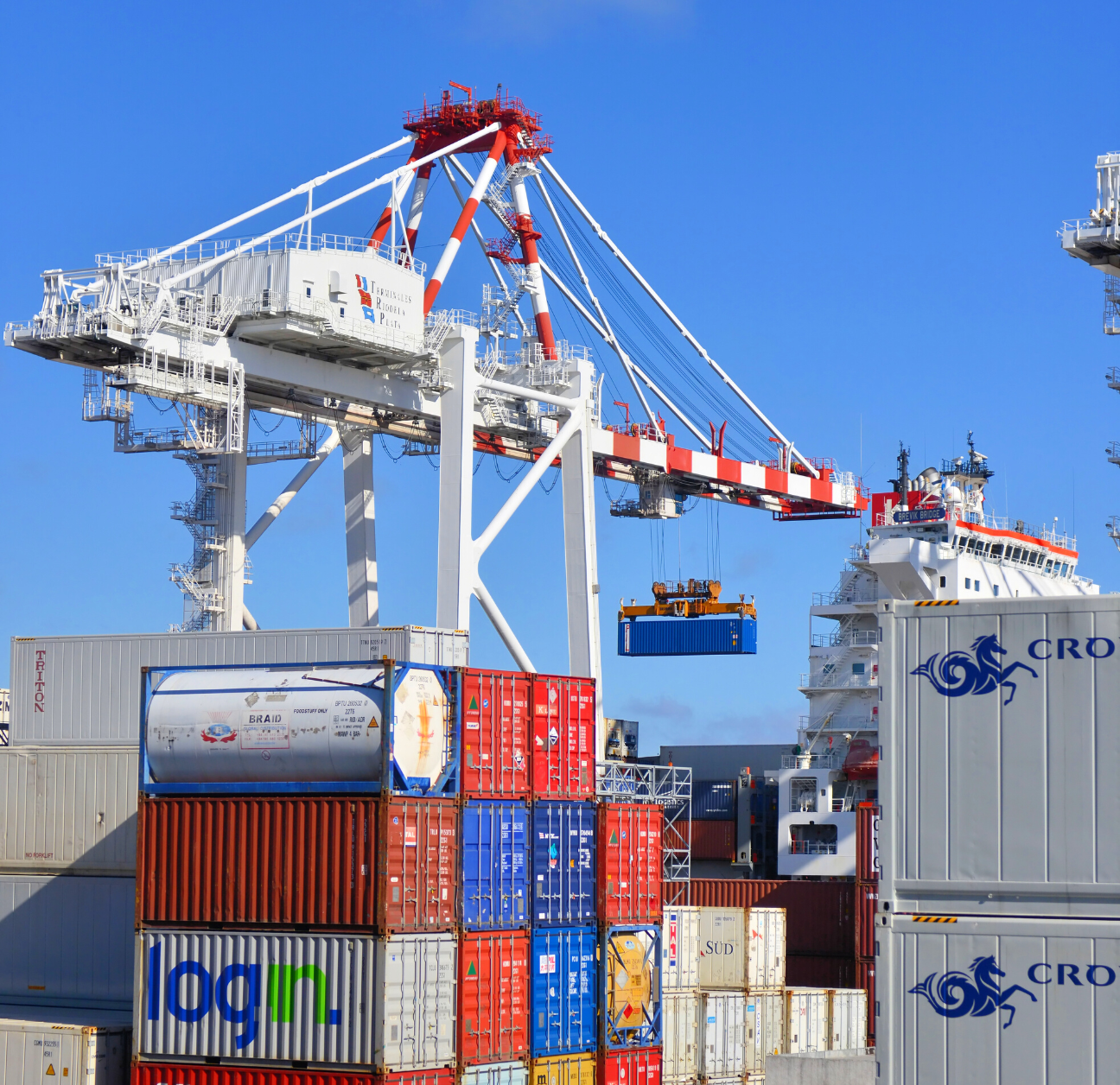 containers being moved via crane in a port