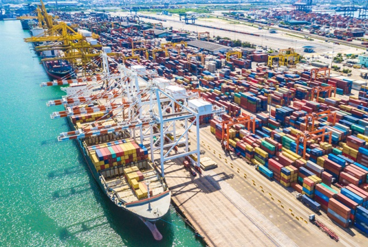 Cargo ship at busy port, integrations for supply chain and logistics